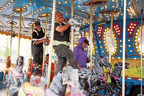01062026
Midway workers polish the carousel ride in preparation for the 2026 Manitoba Summer Fair at the Keystone Centre grounds on Monday. The fair opens Wednesday and runs until Sunday.
(Tim Smith/The Brandon Sun)