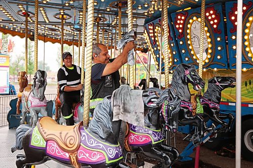 01062026
Midway workers polish the carousel ride in preparation for the 2026 Manitoba Summer Fair at the Keystone Centre grounds on Monday. The fair opens Wednesday and runs until Sunday.
(Tim Smith/The Brandon Sun)