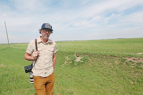 Tim Smith, The Brandon Sun’s only photojournalist, is seen outside a fox den near Brandon in June. Smith photographed several kits and their mother at the den this spring after waiting more than three hours. He said he returns to about a dozen dens in the area every year. (Connor McDowell/The Brandon Sun)