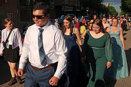 04062026
Upcoming high school graduates parade along Rosser Avenue in downtown Brandon decked out in their graduation attire to applause from visitors to the Brandon Downtown Grad Cruise Night on Thursday evening. The event was part of the monthly Brandon &amp; Area Car Enthusiasts (BACE) and Downtown BIZ cruise night and celebrated the accomplishments of Brandon and area’s 2026 high school graduates. 
(Tim Smith/The Brandon Sun)