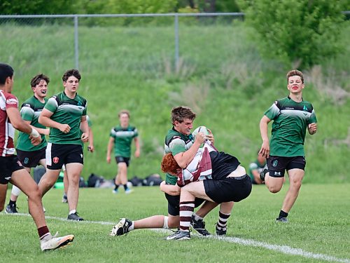 Dauphin's Blake Thacker (6) is stopped in his tracks by St. Paul's Aiden Whiteside (7). (Massimo De Luca-Taronno/The Brandon Sun)