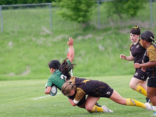Ryann Richard-Soltis (2) of the Dauphin Clippers gets taken down by Steinbach Sabres defender Skyler Munyololo-Muganza (1) during the Manitoba High School Rugby girls provincial championship at John Reilly Field on Saturday. The Clippers fell 31-22 to the Sabres, claiming a silver medal.  (Massimo De Luca-Taronno/The Brandon Sun)