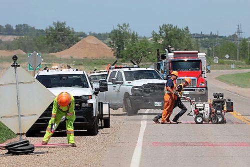09062026
Workers with the province create new rumble strips on Manitoba Highway 110 north of Richmond Avenue on Tuesday as simultaneous work is done on the traffic light system at the intersection of Richmond Avenue and Manitoba Highway 110. 
(Tim Smith/The Brandon Sun)