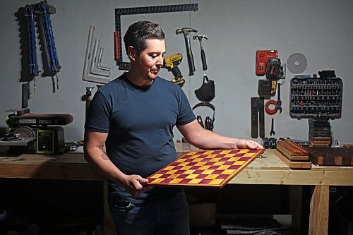 09062026
Jonathan Paddison, owner of Northern Prairie Woodworks, looks over a custom chess board he made at his wood shop in Virden on Tuesday. 
(Tim Smith/The Brandon Sun)