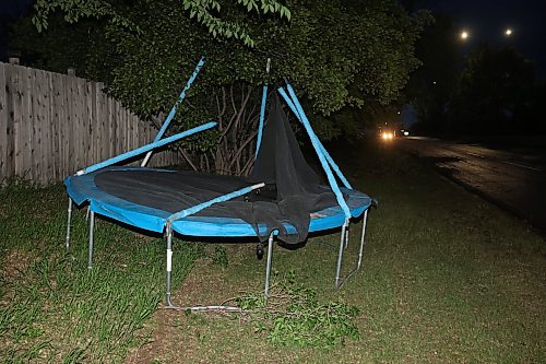 09062026
A damaged trampoline that blew onto 34th Street in Brandon was moved onto grass bordering the road during Tuesday evening’s storm. 
(Tim Smith/The Brandon Sun)