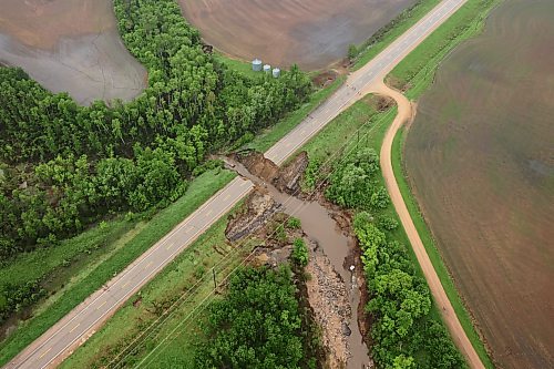 A damaged portion of Highway 10 between Minitonas and Swan River, Manitoba is visible from a helicopter during rain on Wednesday after intense rainfall this week caused widespread flooding in the region. Manitoba Premier Wab Kinew toured the affected areas Wednesday. (Tim Smith/The Brandon Sun)