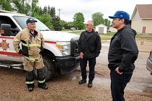 Minitonas Fire Chief Ken Malley speaks with Manitoba Premier Wab Kinew in the community on Wednesday while the Premier toured the damage caused by flooding in the area over the past few days. (Tim Smith/The Brandon Sun)