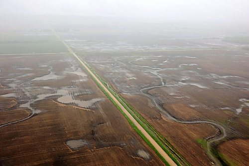 10062026
Flooded farmland between Minitonas and Swan River, Manitoba is visible from a helicopter during rain on Wednesday after intense rainfall this week caused widespread flooding in the region. Manitoba Premier Wab Kinew toured the affected areas Wednesday.
(Tim Smith/The Brandon Sun)