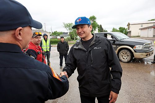 10062026
Manitoba Premier Wab Kinew visits with emergency workers helping out in the community of Minitonas on Wednesday while touring the damage caused by flooding in the area over the past few days.
(Tim Smith/The Brandon Sun)