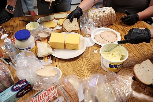 10062026
Volunteers make sandwiches for community members at the Minitonas Early Years School on Wednesday while the community deals with the aftermath of devastating flooding. (Tim Smith/The Brandon Sun)
