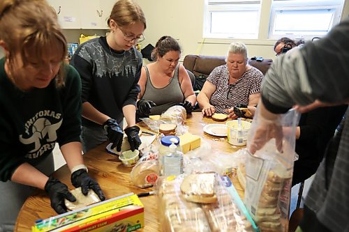 10062026
Volunteers make sandwiches for community members at the Minitonas Early Years School on Wednesday while the community deals with the aftermath of devastating flooding. (Tim Smith/The Brandon Sun)