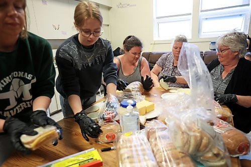 10062026
Volunteers make sandwiches for community members at the Minitonas Early Years School on Wednesday while the community deals with the aftermath of devastating flooding. (Tim Smith/The Brandon Sun)