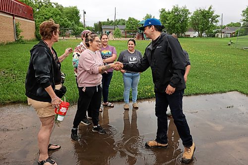 10062026
Manitoba Premier Wab Kinew meets residents of Minitonas and area outside the Minitonas Early Years School on Wednesday while touring the damage caused by flooding in the area over the past few days.
(Tim Smith/The Brandon Sun)