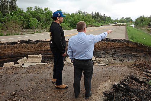 10062026
Manitoba Premier Wab Kinew tours damage to Highway 10 at Tamarack Creek just east of Swan River, Manitoba with Swan River Mayor Lance Jacobson on Wednesday after intense rainfall this week caused the river to swell and damaged the highway. The province cut a section of Highway 10 at the creek to relieve some of the pressure from the swollen creek.
(Tim Smith/The Brandon Sun)
