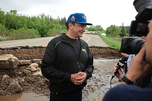 10062026
Manitoba Premier Wab Kinew talks to journalists while touring damage to Highway 10 at Tamarack Creek just east of Swan River, Manitoba on Wednesday after intense rainfall this week caused the river to swell and damaged the highway. The province cut a section of Highway 10 at the creek to relieve some of the pressure from the swollen creek.
(Tim Smith/The Brandon Sun)