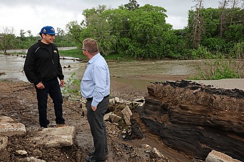 10062026
Manitoba Premier Wab Kinew tours damage to Highway 10 at Tamarack Creek just east of Swan River, Manitoba with Swan River Mayor Lance Jacobson on Wednesday after intense rainfall this week caused the river to swell and damaged the highway. The province cut a section of Highway 10 at the creek to relieve some of the pressure from the swollen creek.
(Tim Smith/The Brandon Sun)
