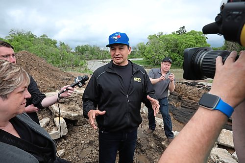 10062026
Manitoba Premier Wab Kinew talks to journalists while touring damage to Highway 10 at Tamarack Creek just east of Swan River, Manitoba on Wednesday after intense rainfall this week caused the river to swell and damaged the highway. The province cut a section of Highway 10 at the creek to relieve some of the pressure from the swollen creek.
(Tim Smith/The Brandon Sun)