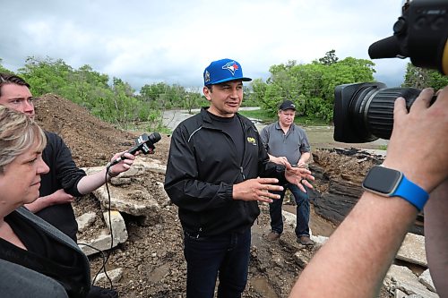 10062026
Manitoba Premier Wab Kinew talks to journalists while touring damage to Highway 10 at Tamarack Creek just east of Swan River, Manitoba on Wednesday after intense rainfall this week caused the river to swell and damaged the highway. The province cut a section of Highway 10 at the creek to relieve some of the pressure from the swollen creek.
(Tim Smith/The Brandon Sun)