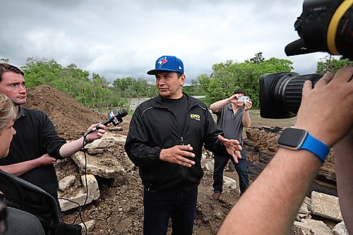 10062026
Manitoba Premier Wab Kinew talks to journalists while touring damage to Highway 10 at Tamarack Creek just east of Swan River, Manitoba on Wednesday after intense rainfall this week caused the river to swell and damaged the highway. The province cut a section of Highway 10 at the creek to relieve some of the pressure from the swollen creek.
(Tim Smith/The Brandon Sun)
