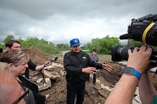 10062026
Manitoba Premier Wab Kinew talks to journalists while touring damage to Highway 10 at Tamarack Creek just east of Swan River, Manitoba on Wednesday after intense rainfall this week caused the river to swell and damaged the highway. The province cut a section of Highway 10 at the creek to relieve some of the pressure from the swollen creek.
(Tim Smith/The Brandon Sun)