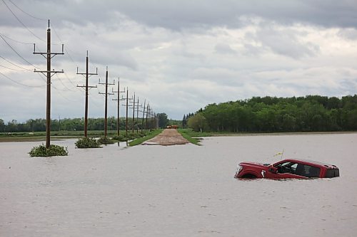 10062026
A pickup trucks sits partially submerged in floodwaters along Highway 83 south of Swan River, Manitoba on Wednesday after sustained rainfall earlier in the week caused widespread flooding. (Tim SmithThe Brandon Sun)
