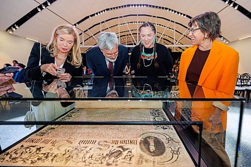 MIKE DEAL / FREE PRESS
Patrita Olasker, vice chair Board of Governors, ROM; Stephen bowman vice chair Board of Governors, ROM; Leslie McCue, Senior Manager of Indigenous Learning and Programs, ROM; and Kat Kupca, Chair of the Manitoba Arts Council,  take a moment to check out the Charter prior to the start of the HBC Royal Charter Welcoming Ceremony and Reception which was held at the Manitoba Museum Thursday morning.
260611 - Thursday, June 11, 2026.