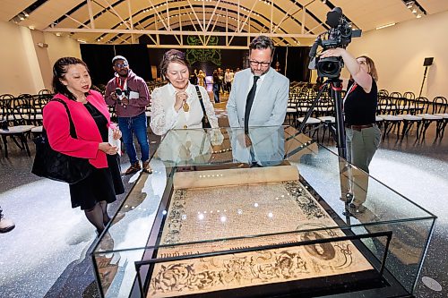 MIKE DEAL / FREE PRESS
(From left) Yoke Chung, Interim Co-Director & CEO, Deputy Director, Museum Operations and Chief Operating Officer at the Royal Ontario Museum (ROM), Stacey Jack, ROM Board of Trustees, and
Brian Astl, vice-chair ROM Board of Trustees, take a look at the Charter before the start of the HBC Royal Charter Welcoming Ceremony and Reception which was held at the Manitoba Museum Thursday morning.
260611 - Thursday, June 11, 2026.