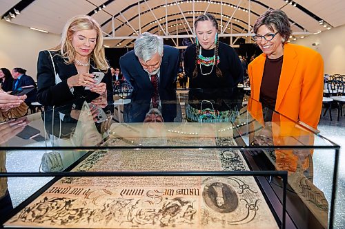 MIKE DEAL / FREE PRESS
Patrita Olasker, vice chair Board of Governors, ROM; Stephen bowman vice chair Board of Governors, ROM; Leslie McCue, Senior Manager of Indigenous Learning and Programs, ROM; and Kat Kupca, Chair of the Manitoba Arts Council, take a moment to check out the Charter prior to the start of the HBC Royal Charter Welcoming Ceremony and Reception which was held at the Manitoba Museum Thursday morning.
260611 - Thursday, June 11, 2026.