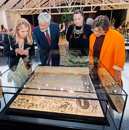 MIKE DEAL / FREE PRESS
Patrita Olasker, vice chair Board of Governors, ROM; Stephen bowman vice chair Board of Governors, ROM; Leslie McCue, Senior Manager of Indigenous Learning and Programs, ROM; and Kat Kupca, Chair of the Manitoba Arts Council,  take a moment to check out the Charter prior to the start of the HBC Royal Charter Welcoming Ceremony and Reception which was held at the Manitoba Museum Thursday morning.
260611 - Thursday, June 11, 2026.