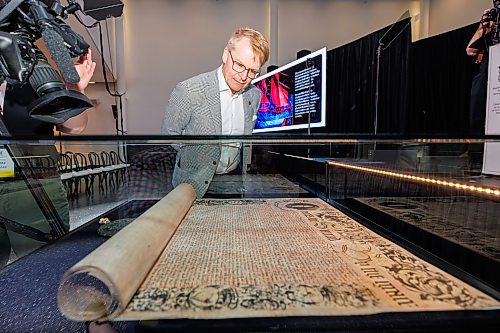 MIKE DEAL / FREE PRESS
Charles Henaire, past board member of Manitoban Museum and retired executive vice-president and deputy CFO with Canada Life takes a look at the Charter before the start of the HBC Royal Charter Welcoming Ceremony and Reception which was held at the Manitoba Museum Thursday morning.
260611 - Thursday, June 11, 2026.