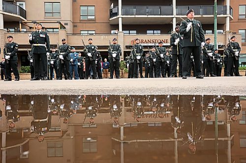 11062026
Soldiers with the 1st Regiment, Royal Canadian Horse Artillery are reflected in a puddle during the Freedom of the City ceremony in front of Brandon City Hall on 9th Street on Thursday morning.
(Tim Smith/The Brandon Sun)