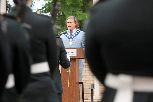 11062026
Brandon Mayor Jeff Fawcett is framed by soldiers with the 1st Regiment, Royal Canadian Horse Artillery while speaking during the Freedom of the City ceremony in front of Brandon City Hall on 9th Street on Thursday morning.
(Tim Smith/The Brandon Sun)