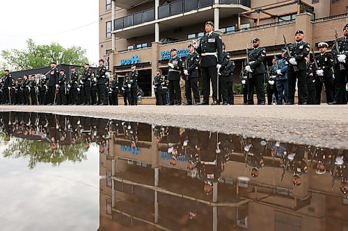 11062026
Soldiers with the 1st Regiment, Royal Canadian Horse Artillery are reflected in a puddle during the Freedom of the City ceremony in front of Brandon City Hall on 9th Street on Thursday morning.
(Tim Smith/The Brandon Sun)