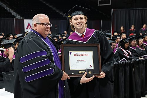 Frison presents the Lieutenant Governor’s Silver Medal plaque to Liam Musgrave. (Abiola Odutola/The Brandon Sun)