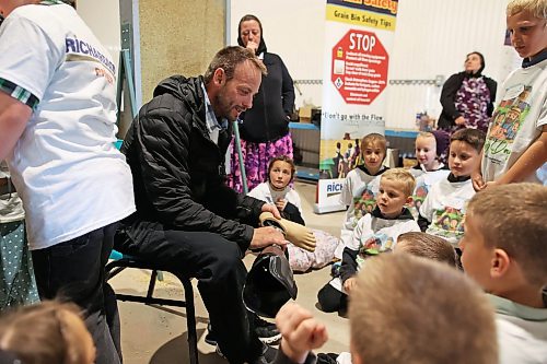 12062026
Jeremy Hofer of Lakeside Colony tells children about how he lost his foot in a grain auger 17 years ago during Colony Safety Day at Rolling Acres Hutterite Colony near Eden, Manitoba on Friday. Hofer was 21 at the time and now wears a prosthetic on his lower left leg. (Tim Smith/The Brandon Sun)