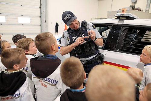 12062026
Cst. Terry Fehr with the Neepawa RCMP detachment shows students how handcuffs work while talking about his roll as an RCMP officer during Colony Safety Day at Rolling Acres Hutterite Colony near Eden, Manitoba on Friday. (Tim Smith/The Brandon Sun)