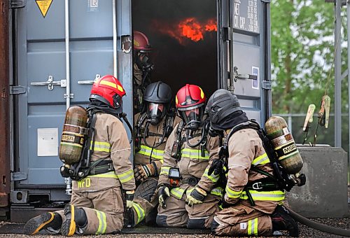 Ruth Bonneville / Free Press

LOCAL - Gillingham fire training

Photo of Mayor Scott Gillingham and Councillor Vivian Santos (red helmets) taking a break from the fire in the sea can. 

Mayor Scott Gillingham and Councillor Vivian Santos participate in the Winnipeg Fire Paramedic Service's Fire Dynamics training program involving being inside a full-involved in a sea can Monday.

See story by Joyana

June 15, 2026