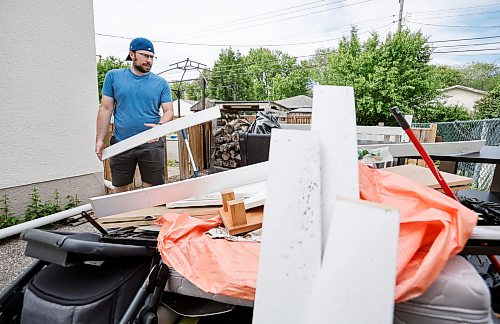 JOHN WOODS / FREE PRESS
Andrew Van Seggelen is photographed Tuesday, June 16, 2026 with water damaged items outside his home after his basement was flooded twice in the past week. 

reporter: modjeski