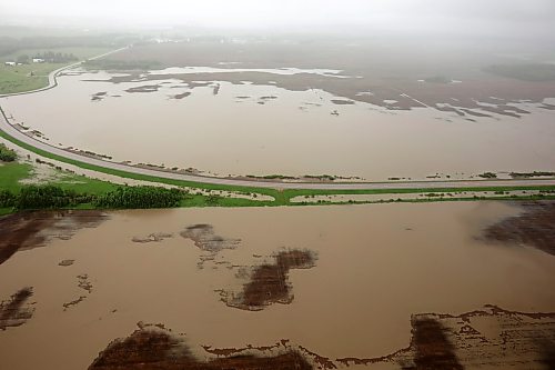 Flooding in farmland along Highway 10 between Minitonas and Swan River is seen from a helicopter last week after intense rainfall caused widespread flooding in the region. Damage to roads and bridges has reduced access to farmland in the area, adding more difficulty for producers coping with flooded farmland, Swan River MLA Rick Wowchuk said Thursday. (Tim Smith/The Brandon Sun files)