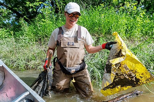 MIKE DEAL / FREE PRESS
Nastassja Loiselle, Lead Hand with the Save Our Seine cleanup crew, gets out of the canoe to pick up some trash caught in a tree Thursday morning. The crew of usually three is out most nice days paddling their way along the Seine River filling up their canoe with heaps of garbage. The portion of the Seine River in the city they are charged with protecting is about 26kms long and they will cover that distance at least four times during the next few months removing garbage and making sure the river is kept as healthy as possible..