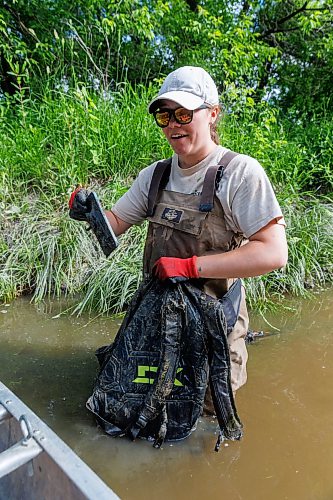 MIKE DEAL / FREE PRESS
Nastassja Loiselle, Lead Hand with the Save Our Seine cleanup crew, emptying a backpack full of water discovers that it contains a bunch of someone’s personal items including a phone and earbuds, Thursday morning. The crew of usually three is out most nice days paddling their way along the Seine River filling up their canoe with heaps of garbage. The portion of the Seine River in the city they are charged with protecting is about 26kms long and they will cover that distance at least four times during the next few months removing garbage and making sure the river is kept as healthy as possible..