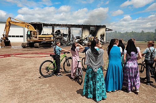 18062026
Colony members watch as firefighters from the Oakland-Wawanesa Fire Department, the Souris-Glenwood Fire Department and Green Acres Colony worked to put out a fire that destroyed the colony’s garage next to their mechanic shop and several vehicles on Thursday. The fire spread through the garage quickly. Several members of the colony are part of the Oakland-Wawanesa Fire Department.
(Tim Smith/The Brandon Sun)