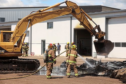 18062026
Firefighters from the Oakland-Wawanesa Fire Department, the Souris-Glenwood Fire Department and Green Acres Colony worked to put out a fire that destroyed the colony’s garage next to their mechanic shop and several vehicles on Thursday. The fire spread through the garage quickly. Several members of the colony are part of the Oakland-Wawanesa Fire Department. 
(Tim Smith/The Brandon Sun)