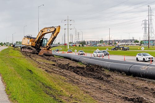 MIKE DEAL / FREE PRESS
Large sewer pipes sit alongside Abinojii Mikanah while they are attached to each other before they will be hauled from the western to the eastern side of the Red River through a tunnel that goes underneath the river.
Construction continues on replacing the old failed sewer lines that crossed the Red River at the Fort Garry Bridge, the new ones being installed in a tunnel that goes 16 meters below the ground travelling underneath the river.
Reporter: Morgan Modjeski
260619 - Friday, June 19, 2026.