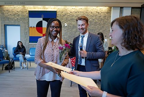 Ruth Bonneville / Free Press
LOCAL - SHELTER U GRAD
Edith Aibangbee from Nigeria, receives her graduation certificate from Seyward Goodhand, the creative writing instructor and Aaron Klassen, Shelter U program director, in the chapel at the Salvation Army Thursday.
Shelter U, a post-secondary institute with a mandate to recruit students experiencing poverty and searching for stable housing, celebrated the end of its pilot with a ceremony for its fourth batch of certificate graduates recently. Booth University College launched the project last winter, working alongside the Salvation Army. Thursday's certificate ceremony/graduation is celebrating the final group of graduates to participate in the pilot program its founder hopes will continue long into the future.
See story by MAGGIE
June 18, 2026