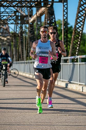 BROOK JONES/FREE PRESS
Simon Berube (left) from Winnipeg, Man., and Harry Halford from Calgary, Alta., cross the BDI bridge while they competes in the half marathon at the Manitoba Marathon in Winnipeg, Man., Sunday, June 21, 2026. Berube won the men's half marathon with a time of 1:05:37 and Halford finished in second with a time of 1:05:58.