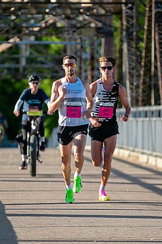 BROOK JONES/FREE PRESS
Simon Berube (left) from Winnipeg, Man., and Harry Halford from Calgary, Alta., cross the BDI bridge while they competes in the half marathon at the Manitoba Marathon in Winnipeg, Man., Sunday, June 21, 2026. Berube won the men's half marathon with a time of 1:05:37 and Halford finished in second with a time of 1:05:58.