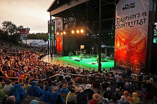 27062025
A big crowd watches as Jackson Dean performs with his band on the main stage in the rain at Dauphin’s Countryfest 2025 south of Dauphin, Manitoba on a hot Friday evening. Josh Ross headlined the main-stage later in the night.
(Tim Smith/The Brandon Sun)