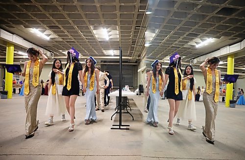 Graduates are reflected in a mirror as they line up for the grand march at the end of the Vincent Massey High School 2026 graduation ceremony at Assiniboine Credit Union Place on Thursday. (Tim Smith/The Brandon Sun)