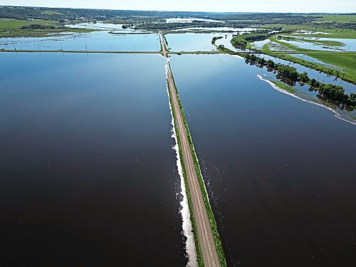 25062026
Flood waters from the swollen Assiniboine River cover farmland and submerge portions of a grid road bisecting Highway 250 north of Alexander on Thursday.
(Tim Smith/The Brandon Sun)default